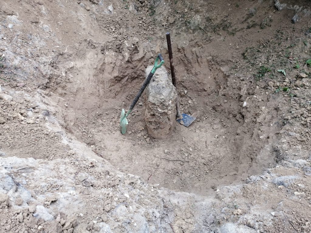 Vertical mound left by itself to support the grey water pipe.