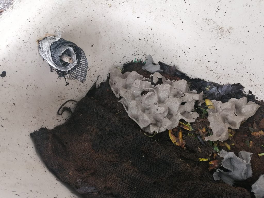 Plugged drainage hole at the top with rolled up mesh and stuffed with a branch to keep rodents out but yet maintain airflow.
