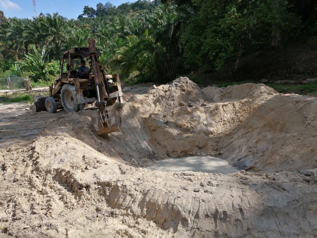 Creating a rim berm around the pond.